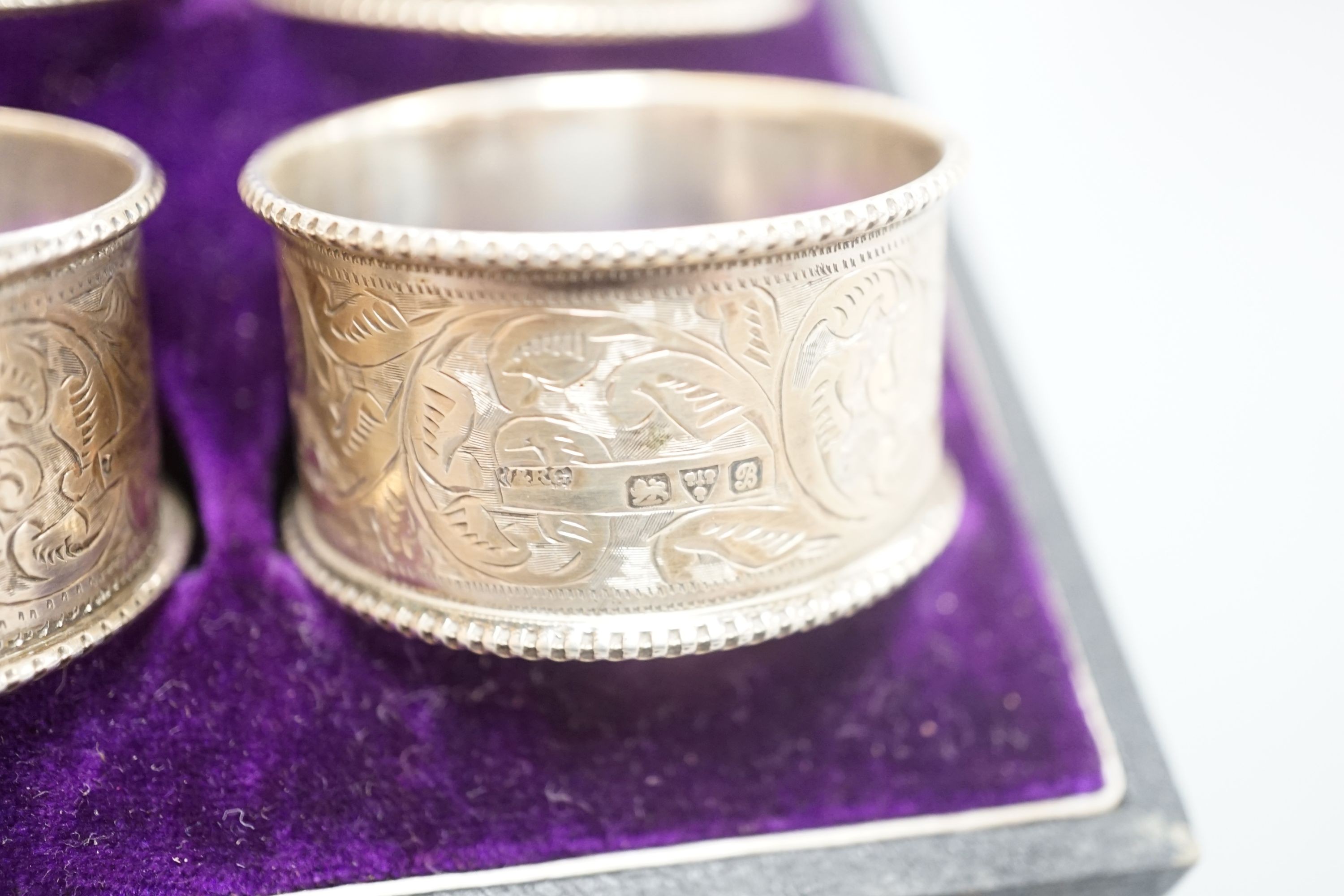 A cased set of six Edwardian engraved silver napkin rings, J & R Griffin, Chester, 1902.